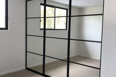 Sliding mirror doors with black aluminium frame with black glazing bars - 3 door combination