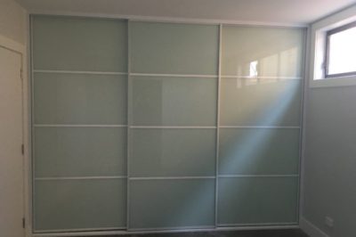 Sliding White Glass Doors with White Glazing Strips